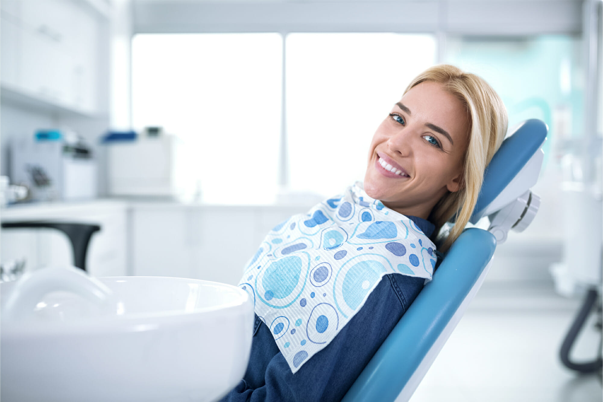 smiling woman sitting in dental exam chair